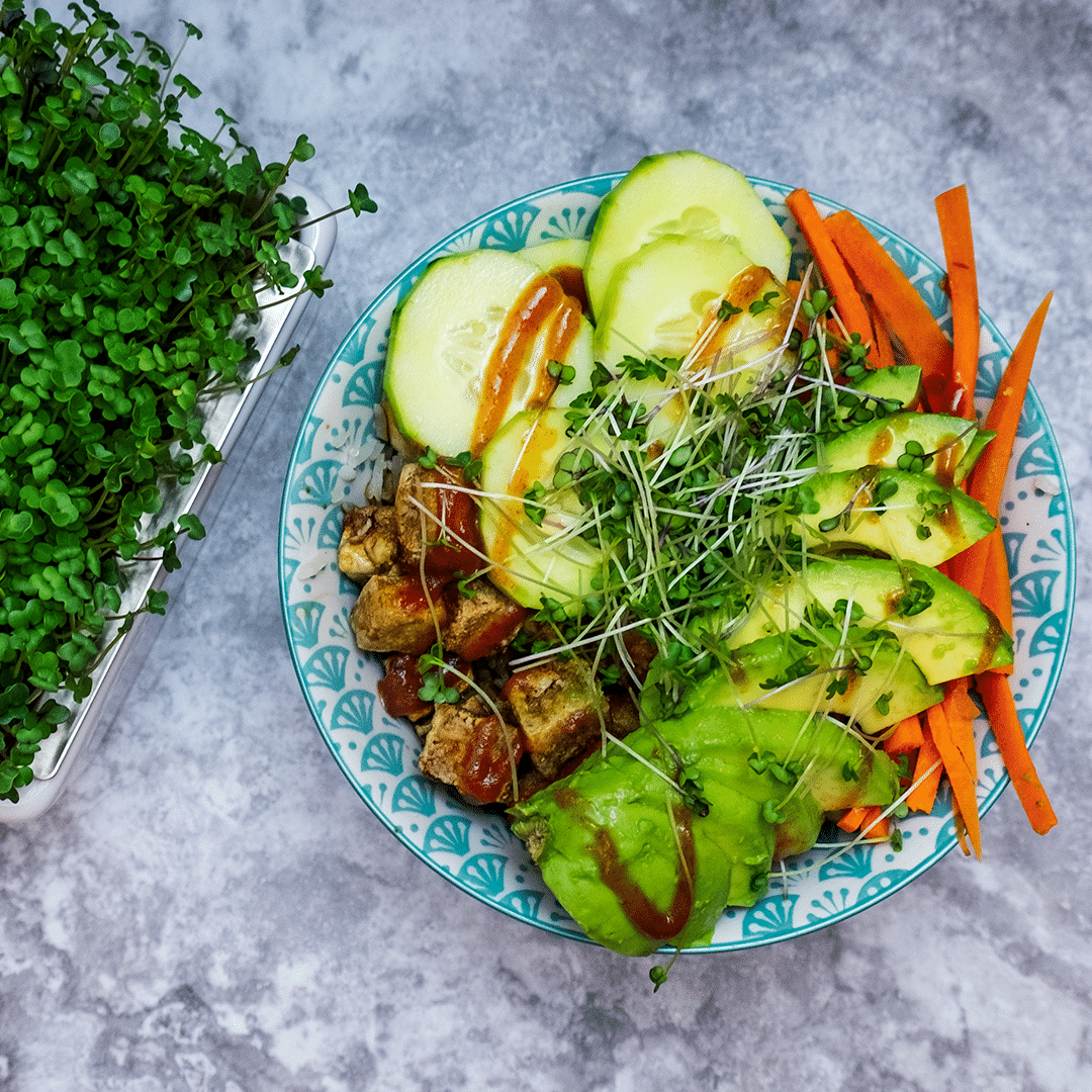 A vegan rice bowl with tofu and vegetables